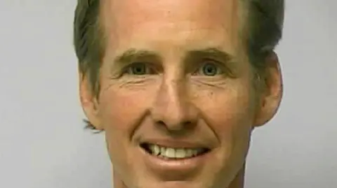 FILE PHOTO: Ryan W. Routh poses in a jail booking photograph in Greensboro, North Carolina, U.S. February 10, 2010.    Guilford County Sheriff’s Office/Handout via REUTERS   THIS IMAGE HAS BEEN SUPPLIED BY A THIRD PARTY. THIS PICTURE WAS PROCESSED BY REUTERS TO ENHANCE QUALITY. AN UNPROCESSED VERSION HAS BEEN PROVIDED/File Photo