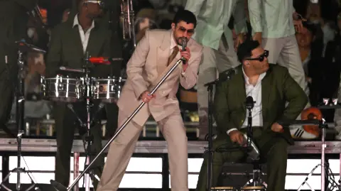 Puerto Rican rapper Bad Bunny performs on stage during his "Debi tirar mas fotos" world tour in Mexico City on December 10, 2025. (Photo by Alfredo ESTRELLA / AFP)