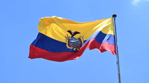 An Ecuadorean flag is pictured at the Carondelet Presidential Palace in Quito on April 14, 2025, the day after the presidential runoff election. Ecuador's President Daniel Noboa claimed a runaway reelection victory after campaigning on a promise to take an "iron fist" to the country's drug cartels. (Photo by Luis ACOSTA / AFP)