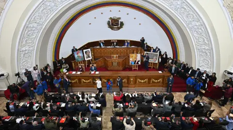 Lawmakers of Venezuela's National Assembly attend a debate on an amnesty bill proposed by Venezuela's interim president Delcy Rodriguez at the National Assembly in Caracas on February 19, 2026. Venezuela's Parliament resumed on February 19 the debate on an amnesty bill that could free hundreds of political prisoners. (Photo by Federico PARRA / AFP)