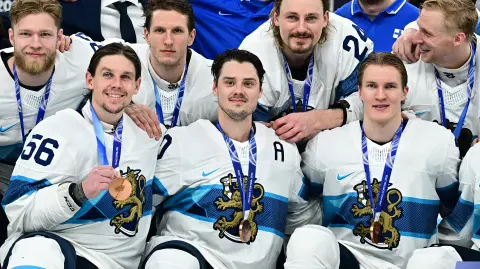Los jugadores de Finlandia celebran con su medalla de bronce .