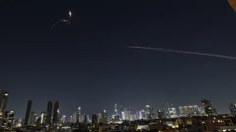 Rocket trails are seen in the sky amid a fresh barrage of Iranian missile attacks above the Israeli coastal city of Tel Aviv on March 3, 2026. (Photo by Jack GUEZ / AFP)