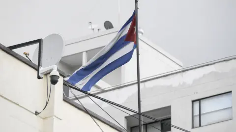 This view shows a Cuban flag at the Cuban embassy in Quito on March 4, 2026. The government of Ecuador expelled Cubas ambassador in Quito, Basilio Gutierrez, on March 4, 2026, and gave him 48 hours to leave the country along with his entire diplomatic mission, the Foreign Ministry said. (Photo by Rodrigo BUENDIA / AFP)