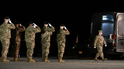 Members of a US Army carry team salute as a flagged-drapped transfer case containing the remains of Sgt. Benjamin N. Pennington, 26, of Glendale, Kentucky, is moved during a dignified transfer solemn event at Dover Air Force Base, in Dover, Delaware, on March 9, 2026. (Photo by Brendan SMIALOWSKI / AFP)