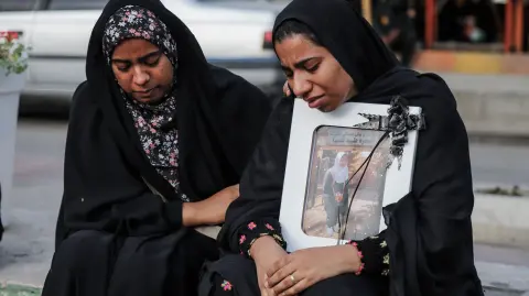 In this picture obtained from Iran's ISNA news agency, mourners attend the funeral of children killed in a reported strike on a primary school in Irans Hormozgan province, in Minab on March 3, 2026. Iranian media have reported hundreds of Iranian casualties, including at a girl's school, although AFP reporters have not been able to verify tolls independently. The war launched by the United States and Israel against Iran spread across the Middle East, threatening to plunge the global economy into chaos, with Lebanon and Gulf energy exporters dragged into the conflict. (Photo by AMIRHOSSEIN KHORGOOEI / ISNA / AFP)