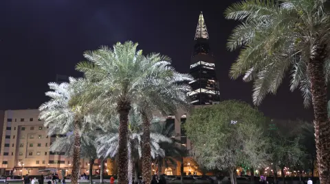 Saudis walk past King Fahad Library in the Saudi capital Riyadh City on March 12, 2026. The oil-rich gulf has borne the brunt of Iran's attack in response to US-Israel strikes that sparked the Middle East war, with Tehran targeting US assets but also civilian infrastructure, including energy facilities and airports. (Photo by AFP) /