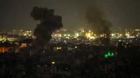 Smoke rises from the site of an Israeli airstrike that targeted an area in Beiruts southern suburbs on March 13, 2026. UN Secretary General Antonio Guterres called on Israel and Hezbollah to "stop the war" at the start of a visit to Beirut, saying it was "no longer the time of armed groups". The UN will launch an urgent humanitarian fundraiser on March 13, to assist the more than 800,000 people registered as displaced in Lebanon. (Photo by AFP) /