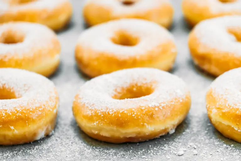 Sweet dessert with many donut on top with sugar icing - Unhealthy food style